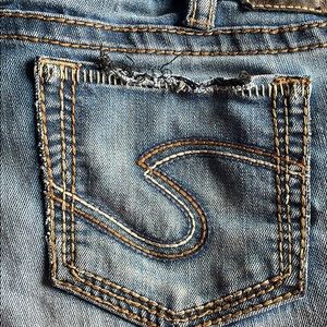 Used silver jeans. They are distressed on the bottom of the legs